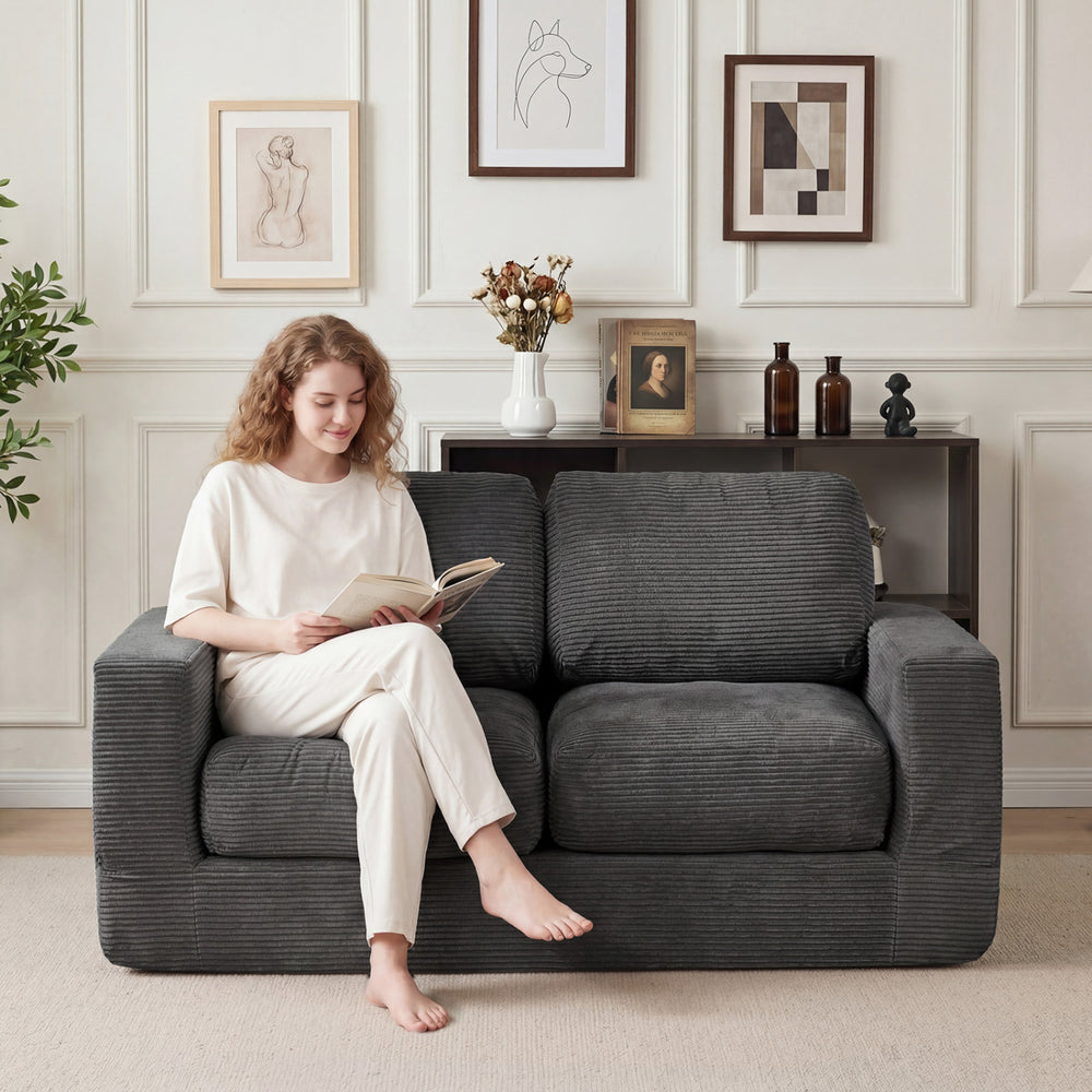 Cozy 2-seater floor couch in black corduroy with removable cover, perfect for relaxing in small spaces.