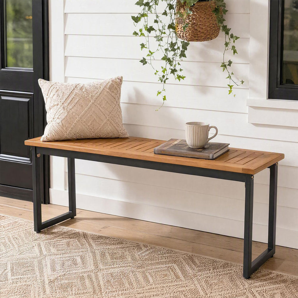Stylish outdoor dining bench with acacia wood top and metal legs, adjustable foot pads for stability on uneven surfaces.