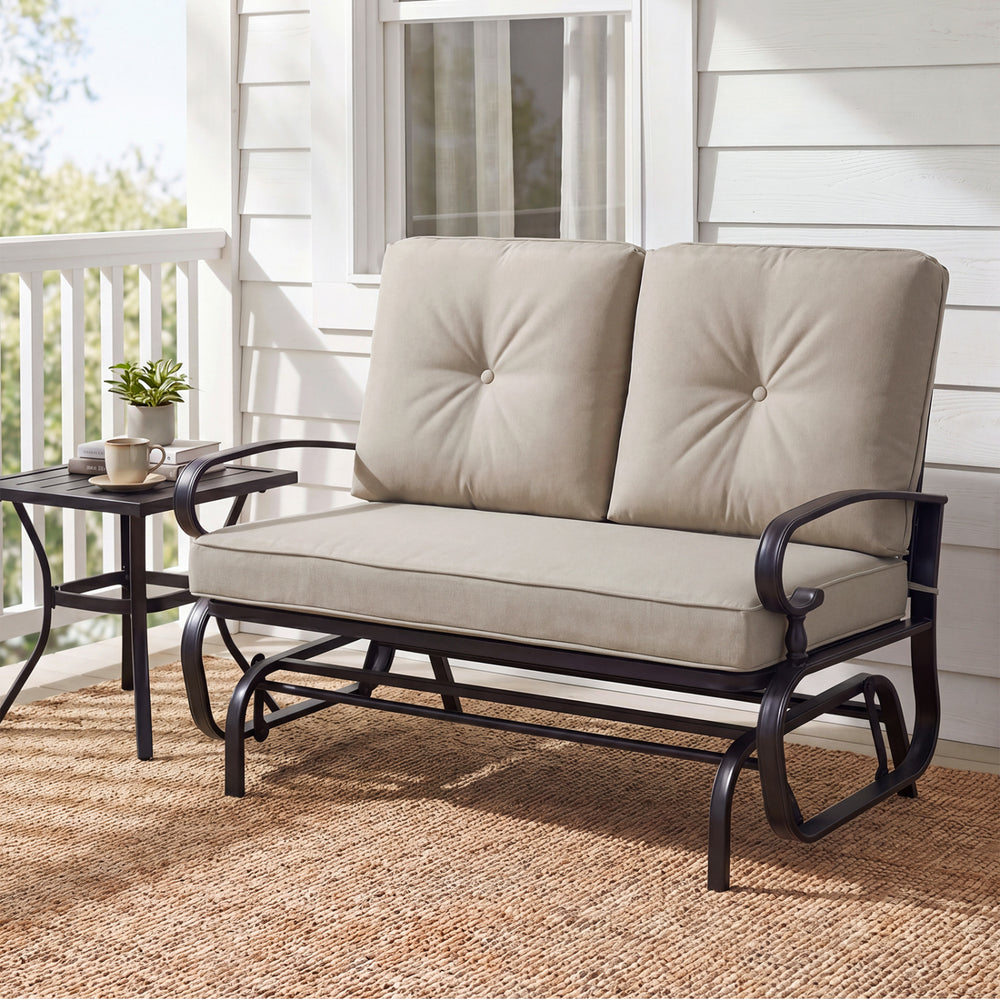 Outdoor swing glider chair for two with beige cushions, sturdy steel frame, and ergonomic design for patio relaxation.