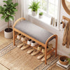 Gray padded cushion on a bamboo shoe bench with slatted shelf, perfect for comfortable shoe storage in hallway or.