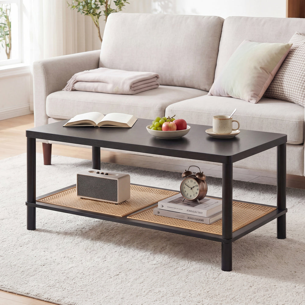 Rectangular black 2-tier coffee table with rubber wood frame and PVC rattan shelf, ideal for living room organization.