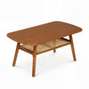 Boho rattan coffee table with rounded corners, walnut finish, featuring a spacious top and open shelf for rustic decor.