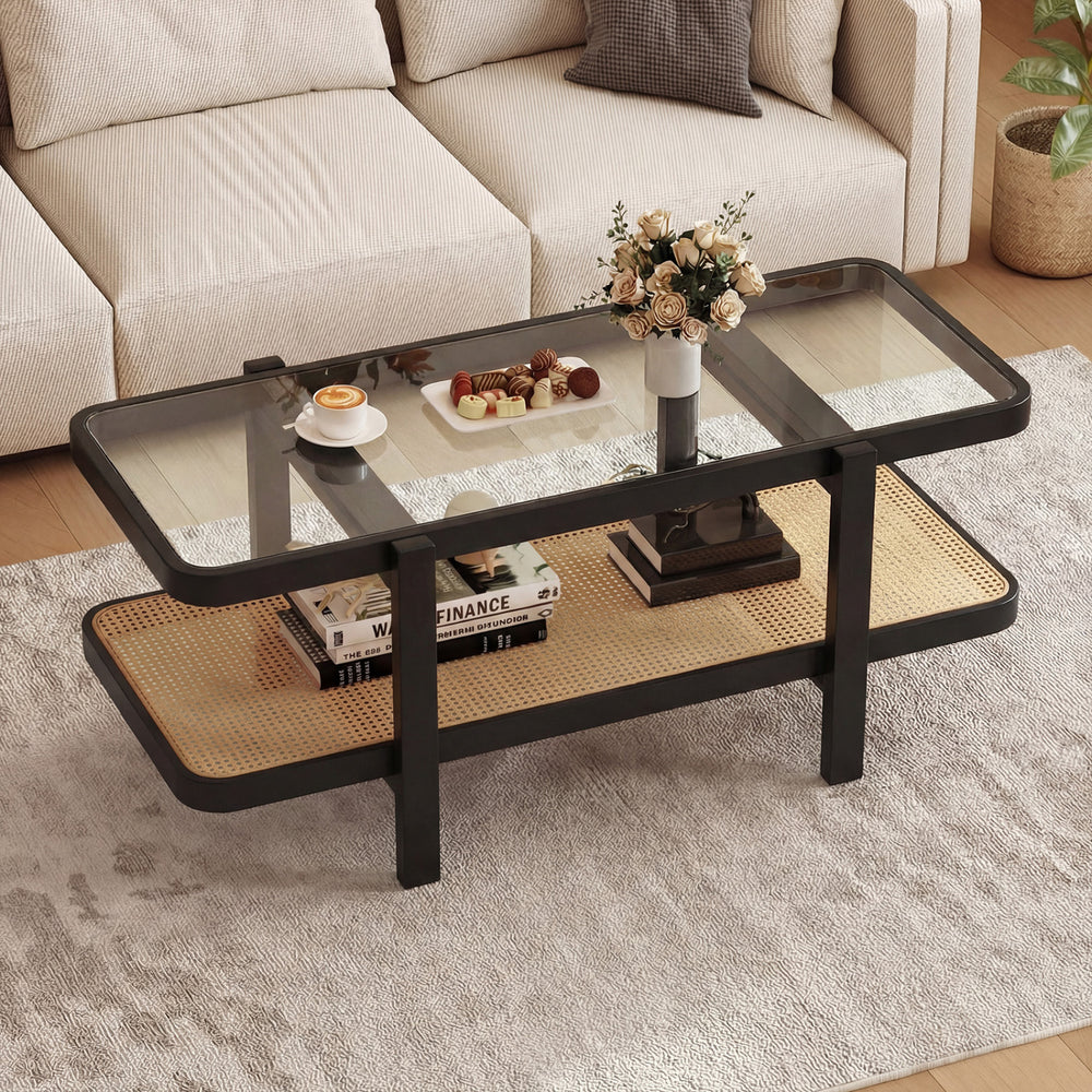 2-tier coffee table with black acacia wood frame and tempered glass top, featuring a rattan shelf for stylish storage.