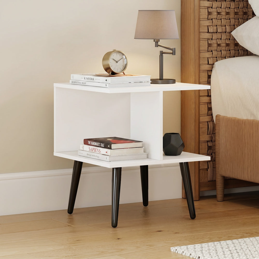 White 2-tier mid century modern end table with raised metal legs, perfect for bedside or living room use.