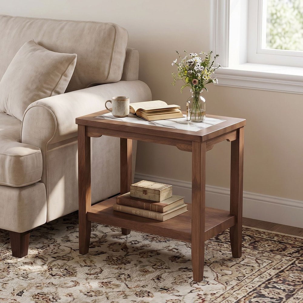 Walnut 2-tier narrow side table shown front-on, styling a marble-inspired tempered glass top and lower shelf beside a sofa.