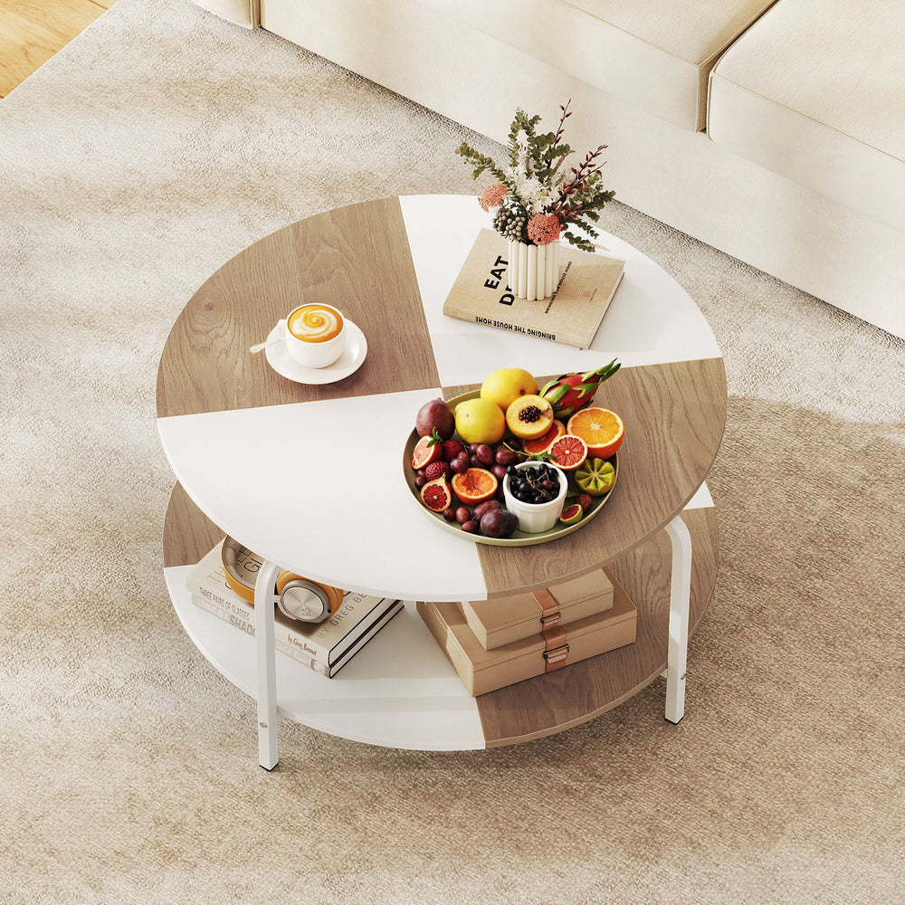 Round coffee table with a split-color tabletop, metal frame, and storage shelf, perfect for organizing daily items.