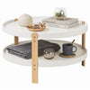 Round 2-tier coffee table with solid beech wood legs, offering open storage for books and decor in a modern living room.