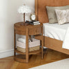Round end table with oak finish, featuring a drawer and lower shelf, ideal for mid-century modern bedroom decor.