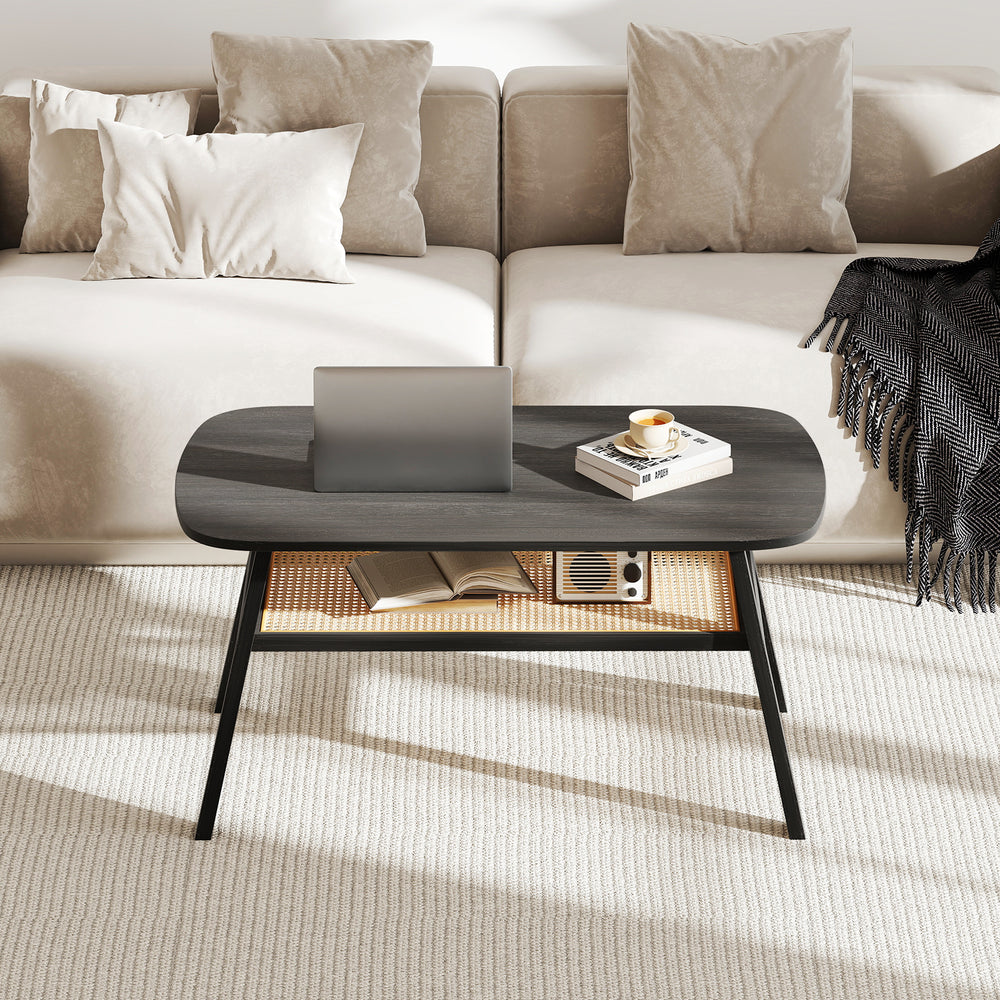 Rectangular coffee table with rattan storage shelf, dark gray wood-grain surface, and rubber wood legs for stability.