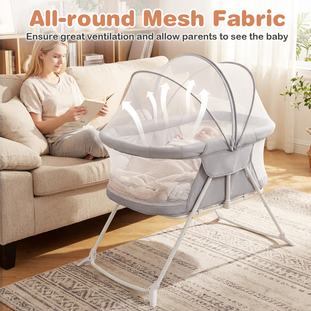 Baby bassinet in grey with all-round mesh fabric for ventilation, featuring a zippered canopy for extra protection.