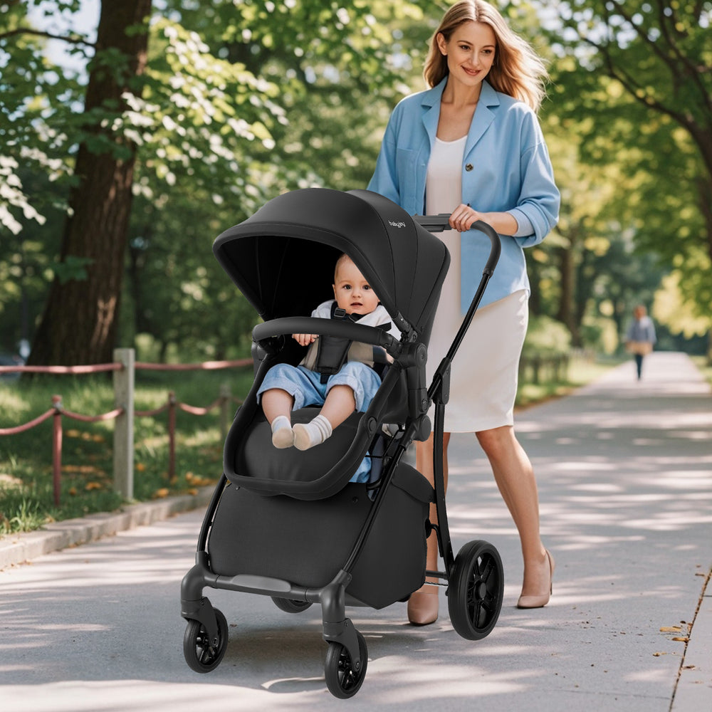 2-in-1 baby stroller in black with adjustable canopy and reversible seat, perfect for outdoor walks and easy transport.