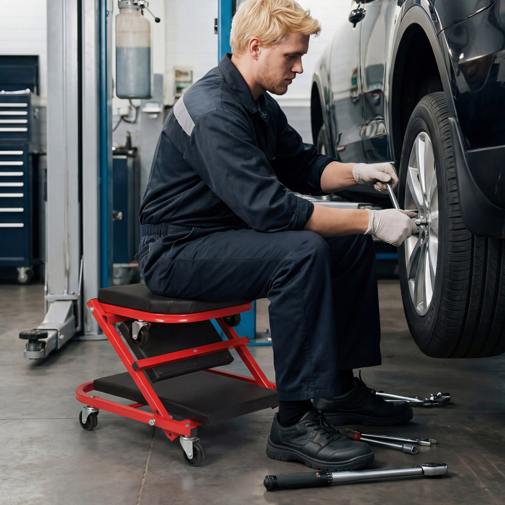 Z-shaped rolling garage stool in use, featuring a cushioned seat and smooth-rolling wheels for automotive repair.