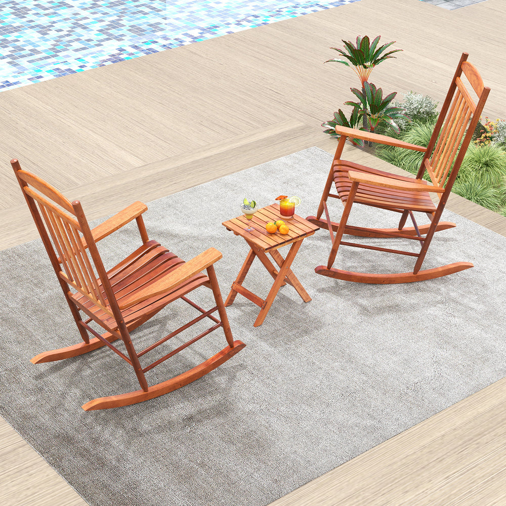 Two natural poplar wood rocking chairs with a folding side table, perfect for outdoor relaxation on the patio.