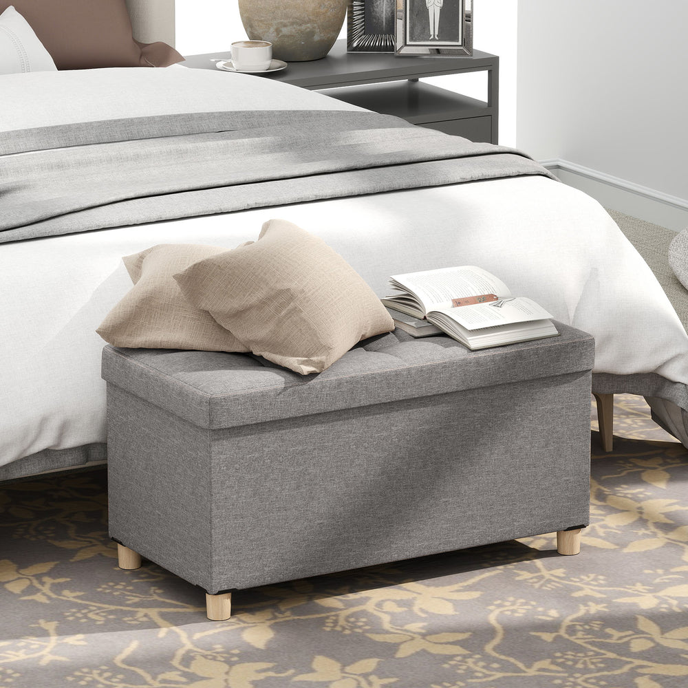 Gray storage ottoman bench with rubber wood legs, featuring a flip-over lid and 20.5-gallon capacity for versatile use.