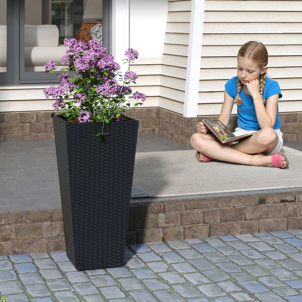 Tall black flower pot made of PE rattan, featuring an open-ended base for drainage, ideal for patios and entrances.