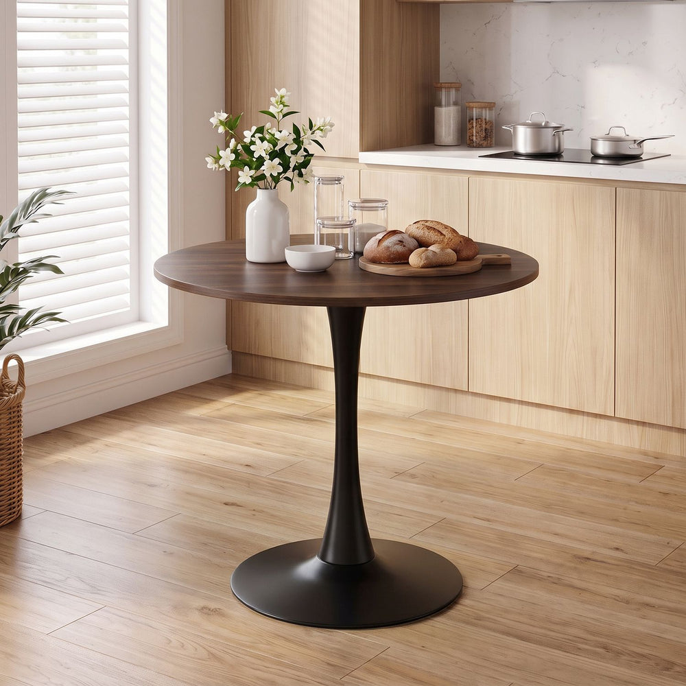 Round 31.5-inch walnut tulip table with metal pedestal, ideal for small spaces in dining rooms or cafes.