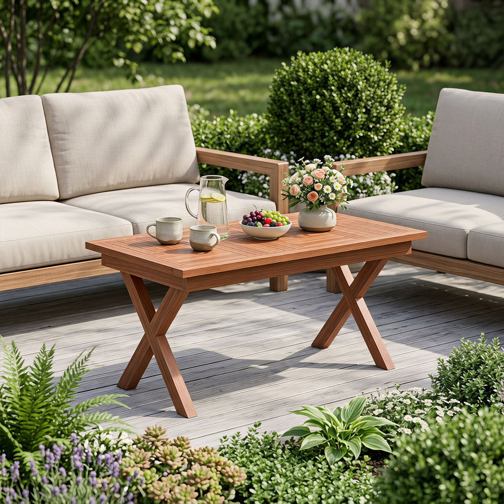 Teak wood coffee table with slatted tabletop, X-shaped legs, perfect for outdoor patio or garden use.