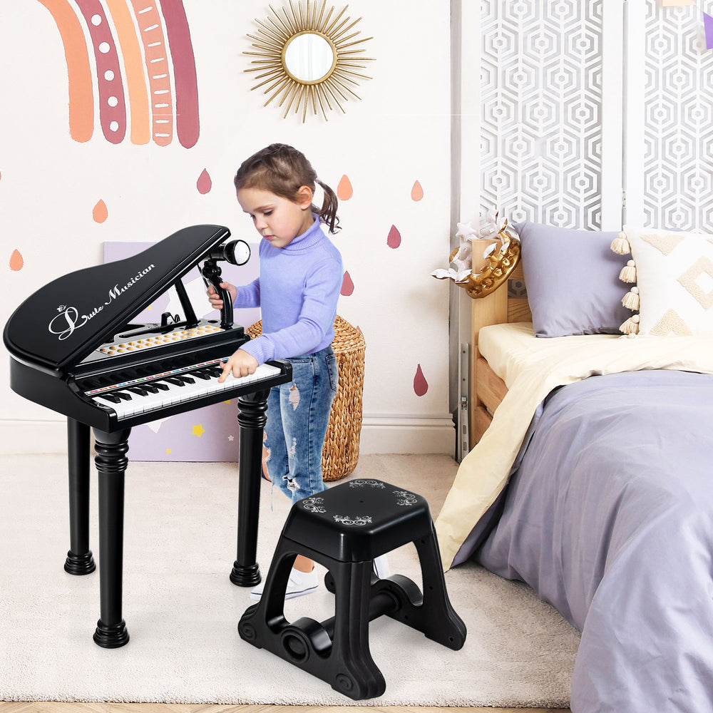 Kids piano keyboard in black with stool, featuring LED lights, microphone, and fun stickers for musical learning.