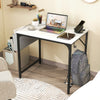 Compact 32-inch computer desk in white with a charging station, metal hook for accessories, and adjustable foot pads.