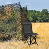 Black foldable 360-degree swivel chair with iron frame, set in a field, ideal for outdoor use and easy transport.