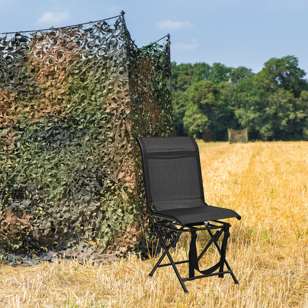 Black foldable 360-degree swivel chair with iron frame, set in a field, ideal for outdoor use and easy transport.