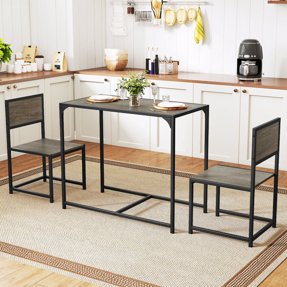 Compact dining set with oak finish table and 2 chairs, featuring a sturdy metal frame for small spaces.