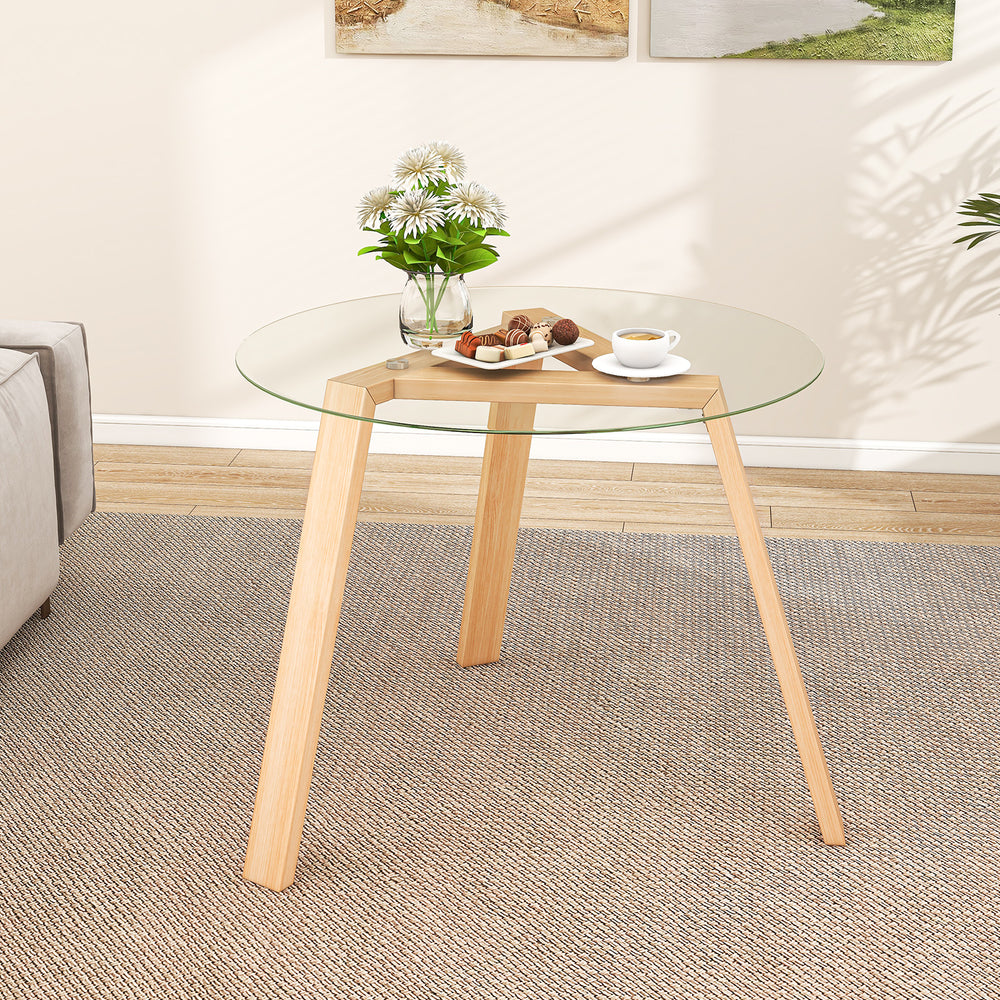 Round glass dining table with a natural rubber wood frame, 36" wide, suitable for living room or dining room use.