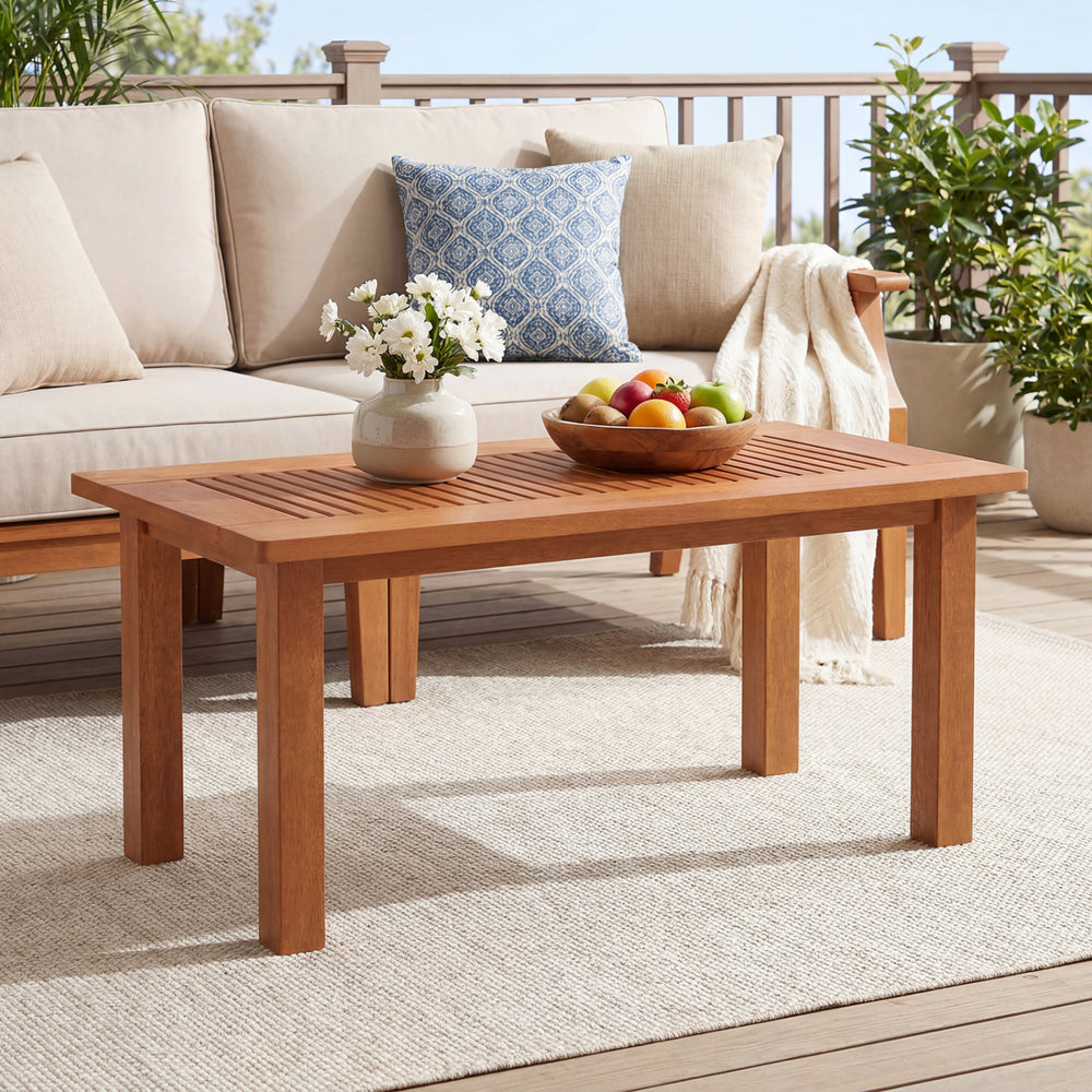 Rectangular outdoor coffee table with slatted top, solid hardwood construction, perfect for backyard styling and.