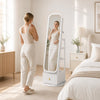 Full-length mirror jewelry cabinet in white with swivel base, dual hooks, and drop-down makeup shelf for versatile storage.