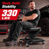 Mechanic creeper with 1.5" padded seat, 330 lbs capacity, and 6 wheels for easy mobility in garage or workshop use.
