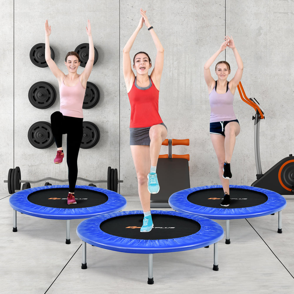 Three women exercising on 36-inch blue mini folding trampolines, showcasing fitness and recreational use.