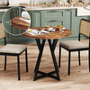 Round dining table with rustic brown wood-grain surface and sturdy X-shaped metal base, ideal for various settings.
