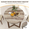 Round 36-inch dining table with grey wood grain finish, wing-shaped pedestal base, perfect for cafes or kitchens.