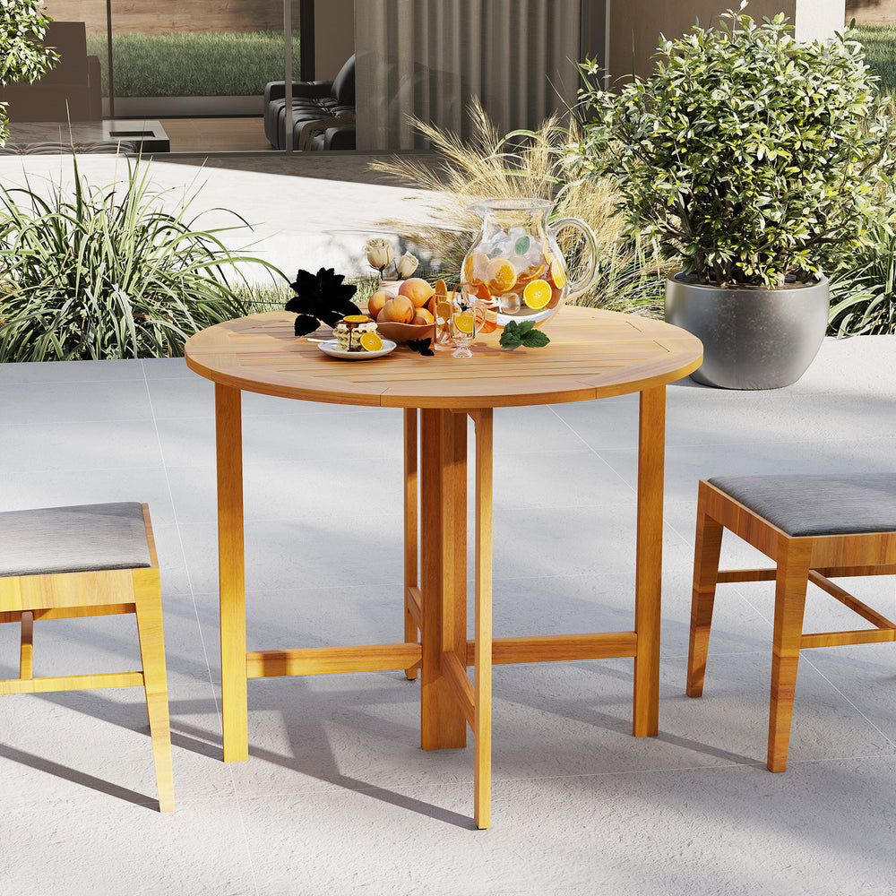 Round 36-inch outdoor folding dining table made of acacia wood, perfect for backyard gatherings and easy storage.