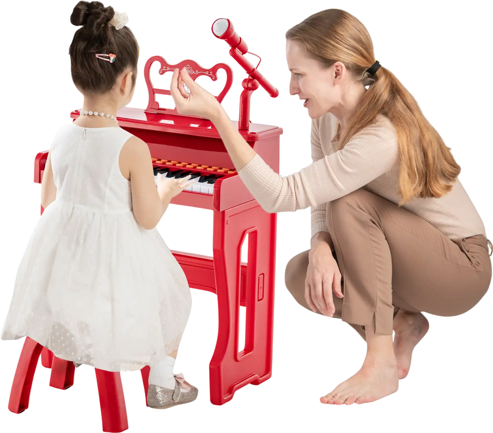 Child playing the red 37 keys music piano with microphone, featuring a detachable music stand and sturdy stool.