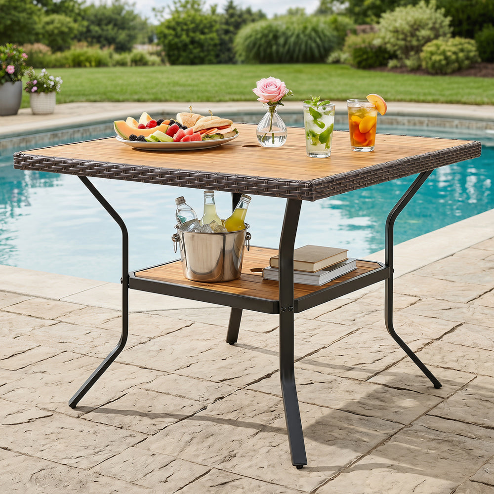 Square outdoor dining table for 4 with acacia wood top, wicker-wrapped edges, and 2" umbrella hole for versatile use.