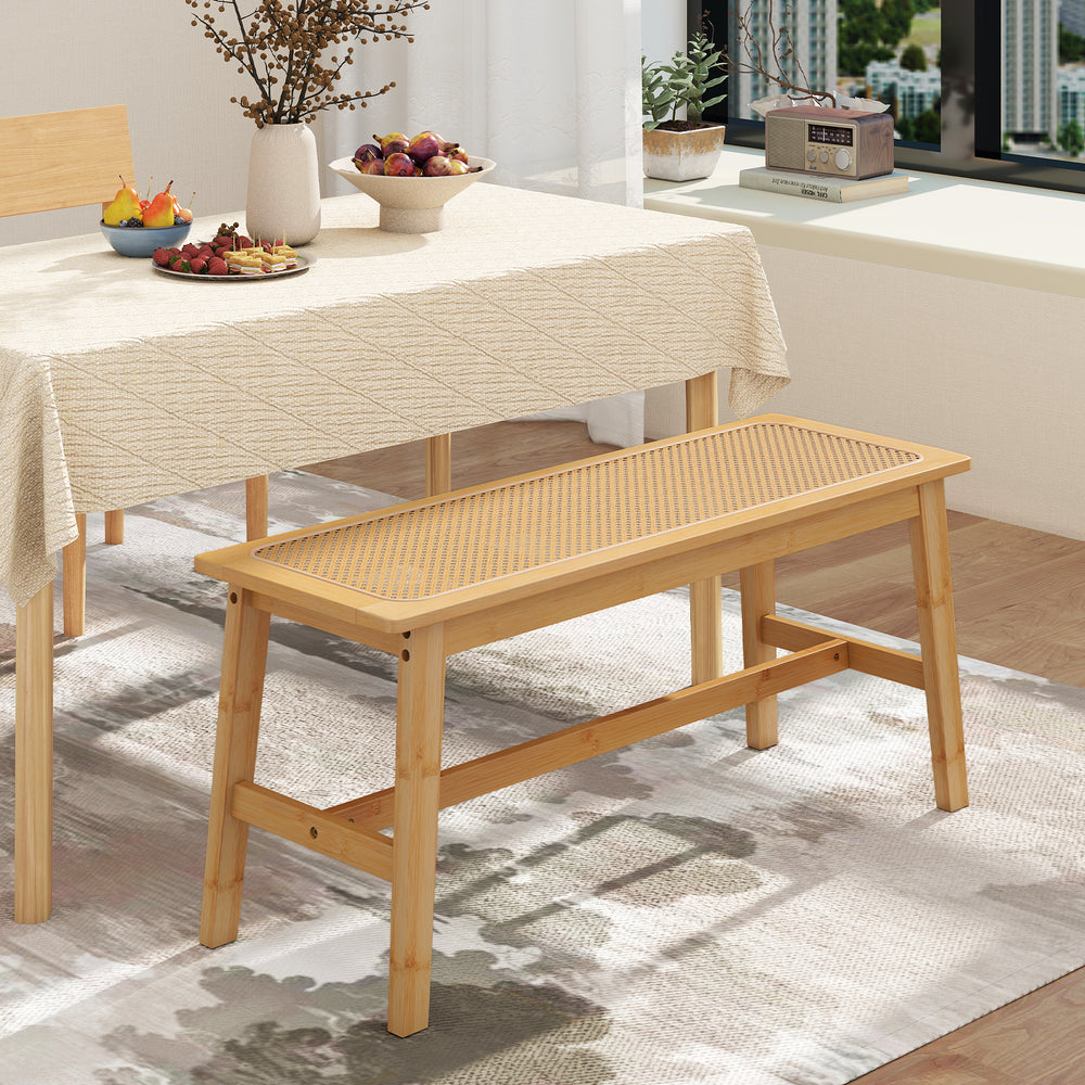 Bamboo dining bench with handwoven rattan seat, 39.5 inches long, perfect for indoor or outdoor seating.