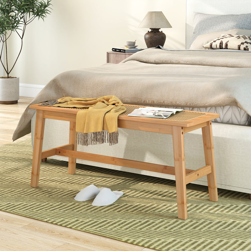 Bamboo dining bench with a handwoven rattan seat, showcasing a natural aesthetic and robust canvas back for added.