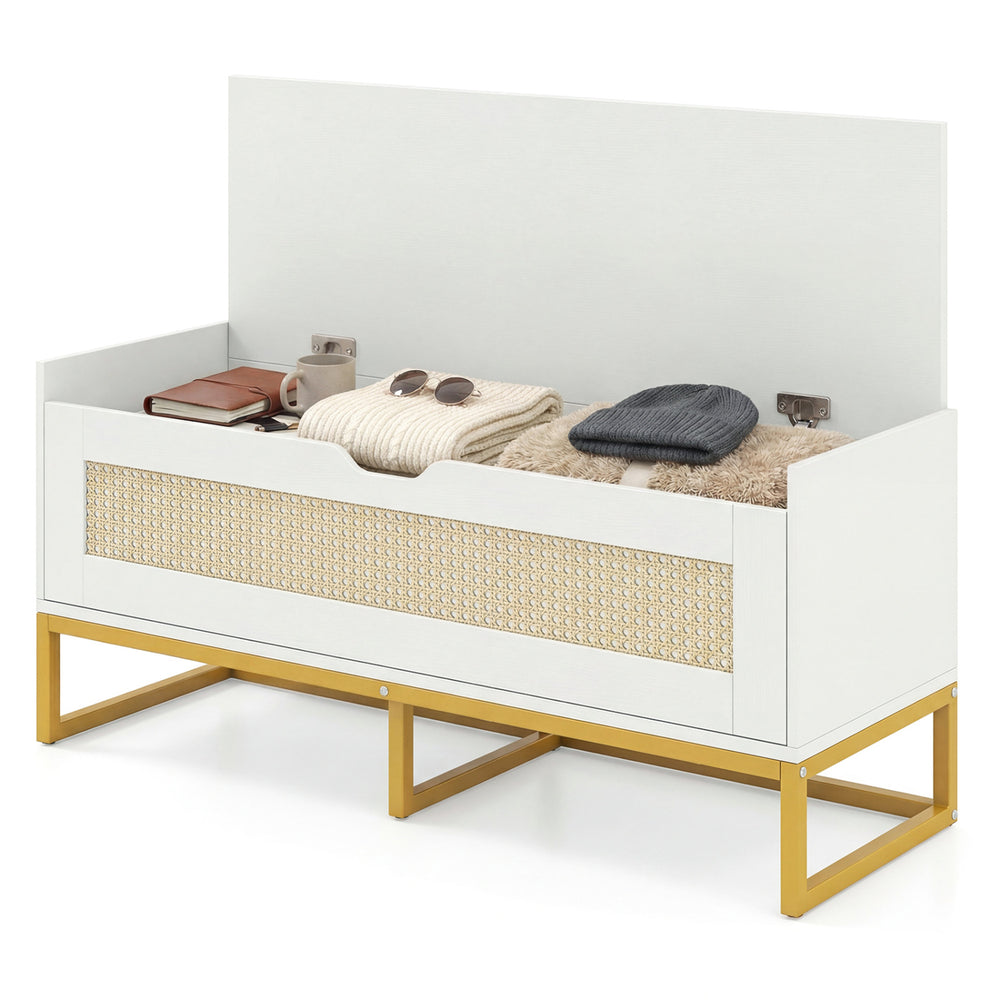 Rattan storage chest with padded seat, white finish, and gold metal legs, ideal for entryway or bedroom organization.