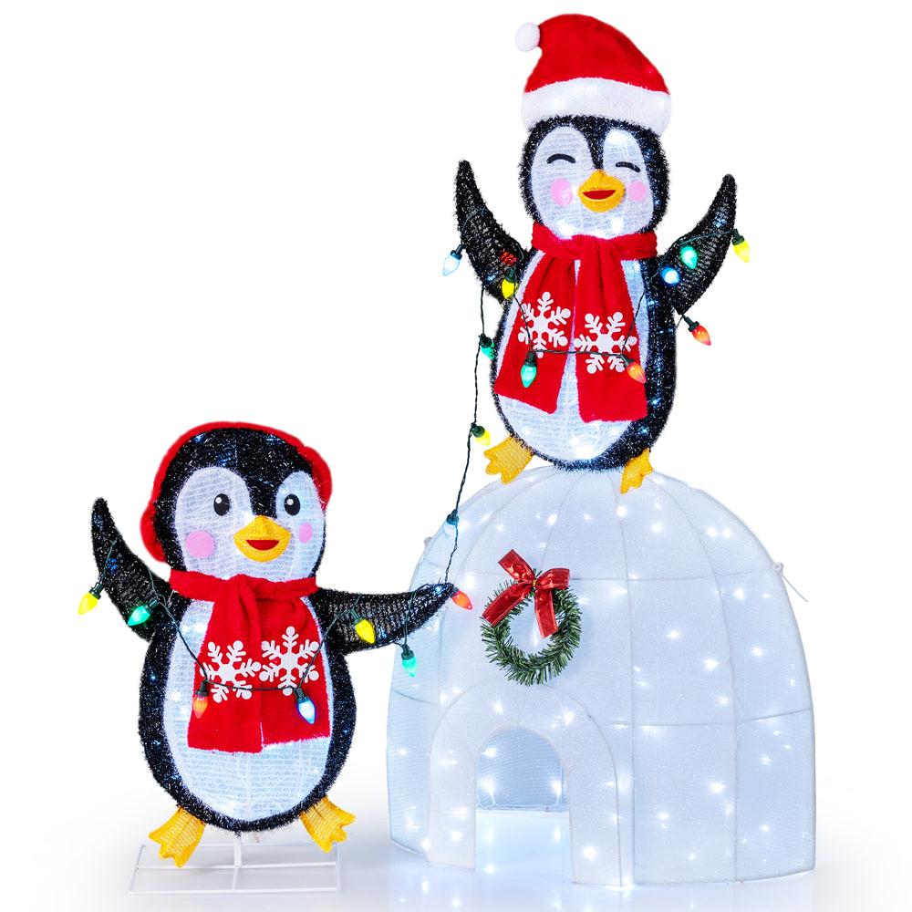 3D pre-lit penguins with scarves beside an igloo, featuring 170 cold-white LED lights for festive indoor or outdoor.