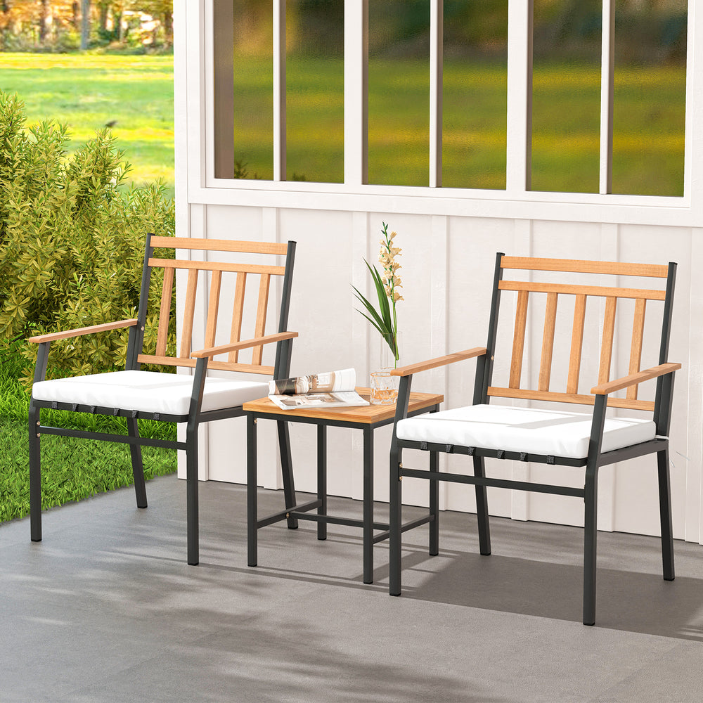Three-piece outdoor furniture set featuring acacia wood chairs and table with white cushions for patio relaxation.
