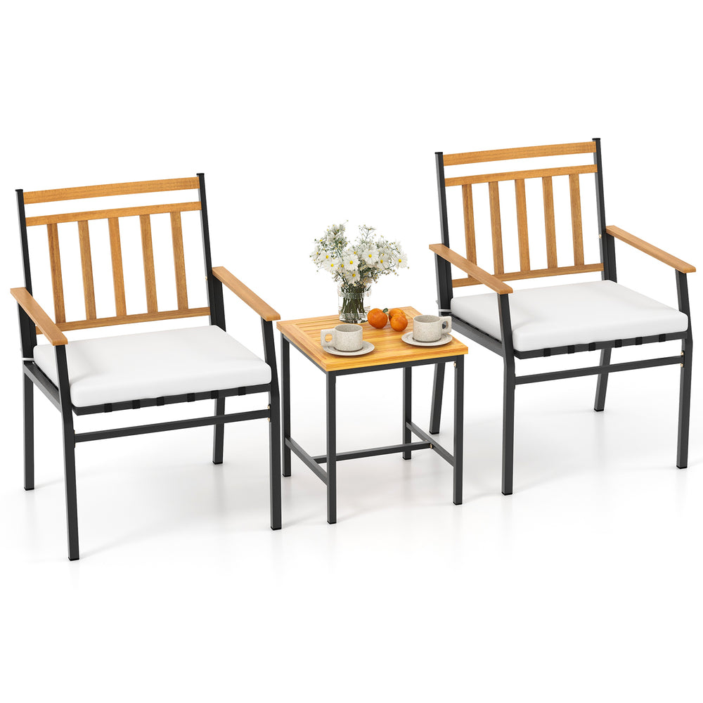 Two ergonomic outdoor chairs with acacia wood accents and soft white cushions, paired with a matching table for patio.