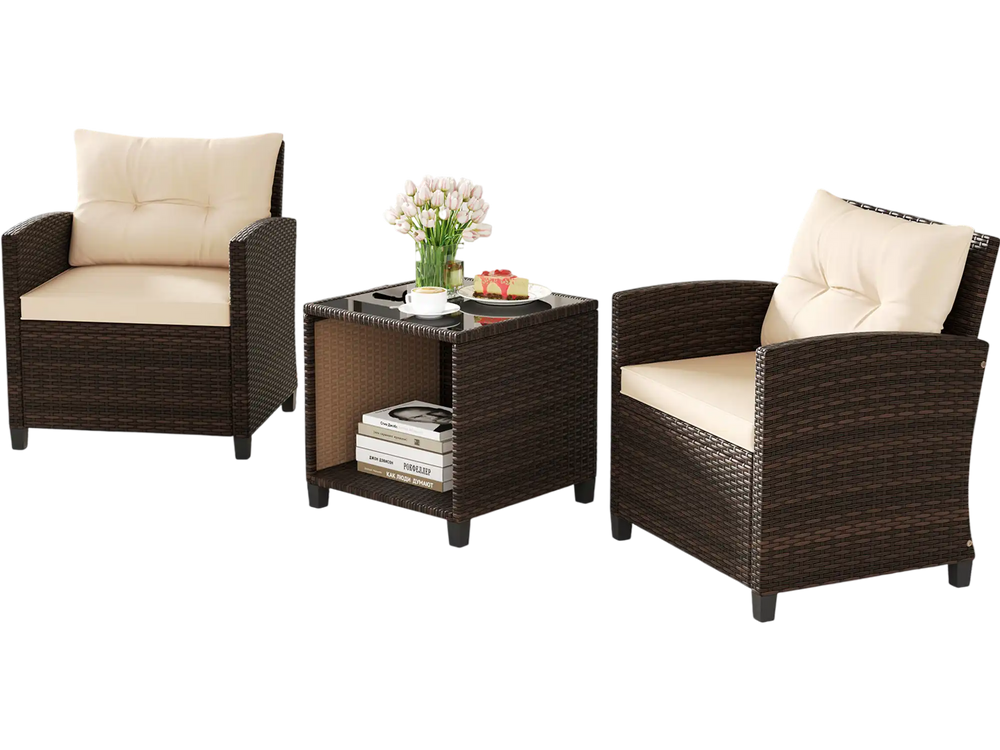 Two wicker chairs with beige cushions and a coffee table, perfect for outdoor relaxation in a patio setting.
