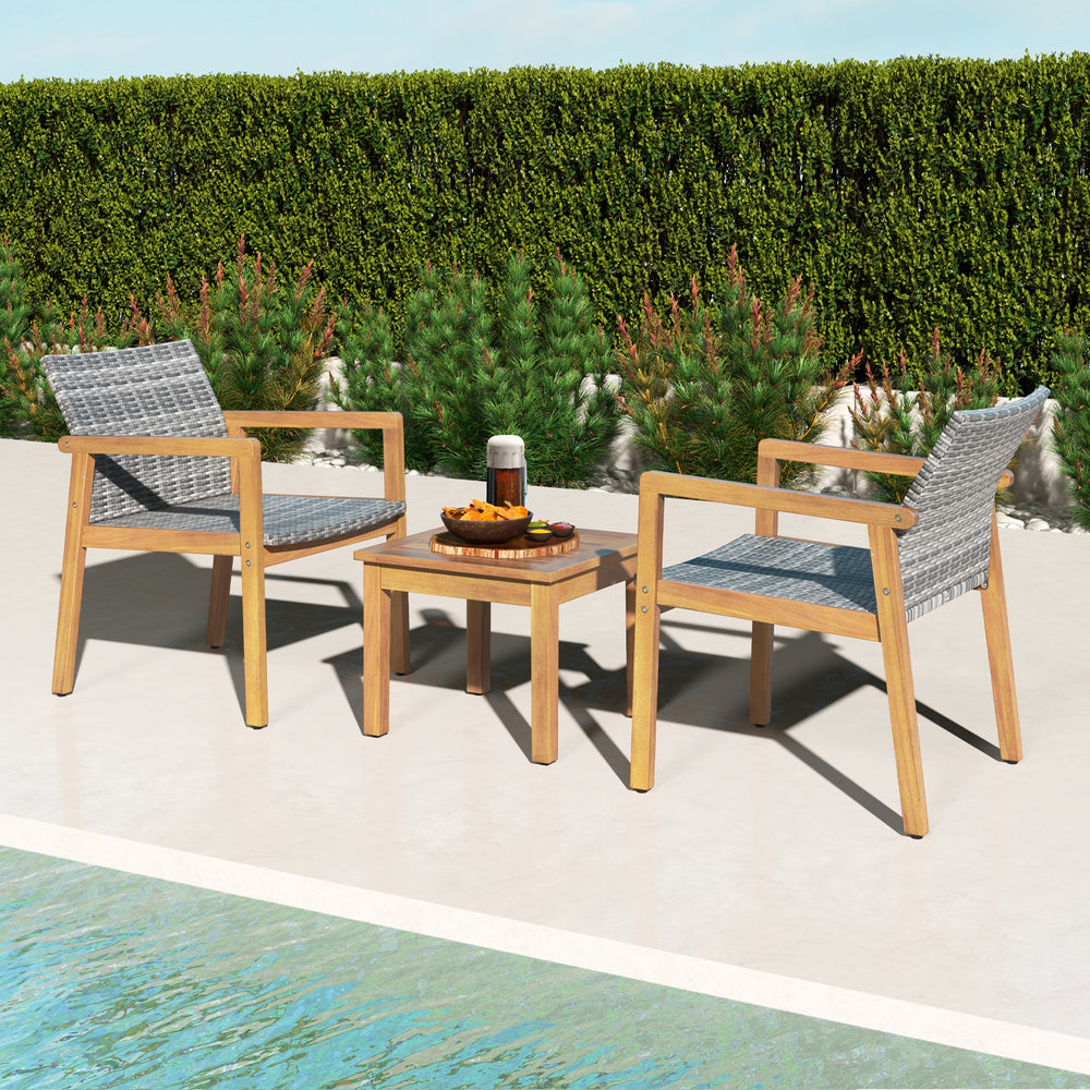 Two acacia wood chairs with hand-woven PE rattan and a coffee table, perfect for patio relaxation.