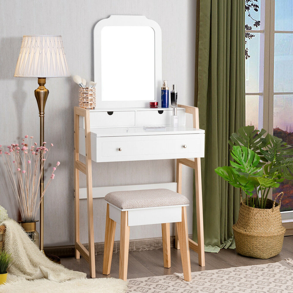 Vanity table set with large mirror and cushioned stool, featuring white finish and three storage drawers for cosmetics.