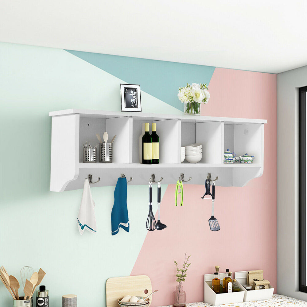 Wall-mounted storage cabinet with four compartments and five hooks, made of durable hard density board for versatile.