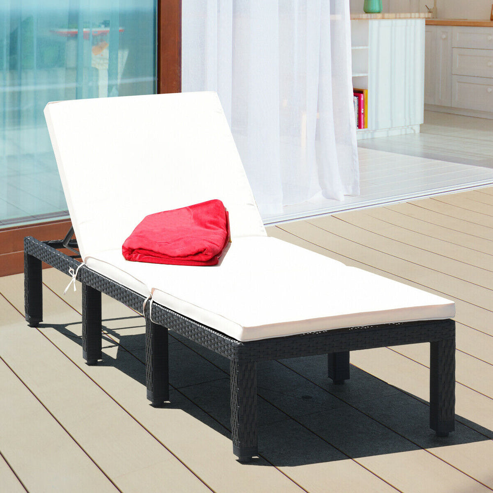 Height-adjustable rattan lounge chair with white cushion, perfect for patio or poolside relaxation.