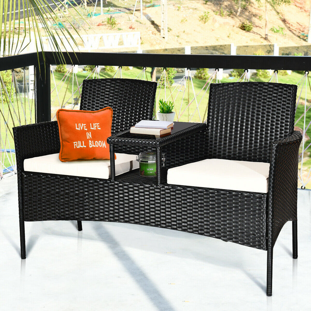 Wicker patio conversation set with removable cushions and table, featuring a durable steel frame for outdoor use.