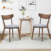 Set of 2 dining chairs with upholstered curved back and rubber wood legs, perfect for kitchen or dining room use.