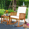Acacia wood patio rocking chair set with thick cushions, perfect for outdoor relaxation in a garden or backyard.